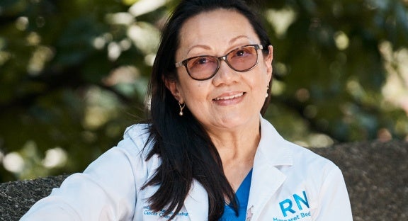 Photograph of doctor in white lab coat.