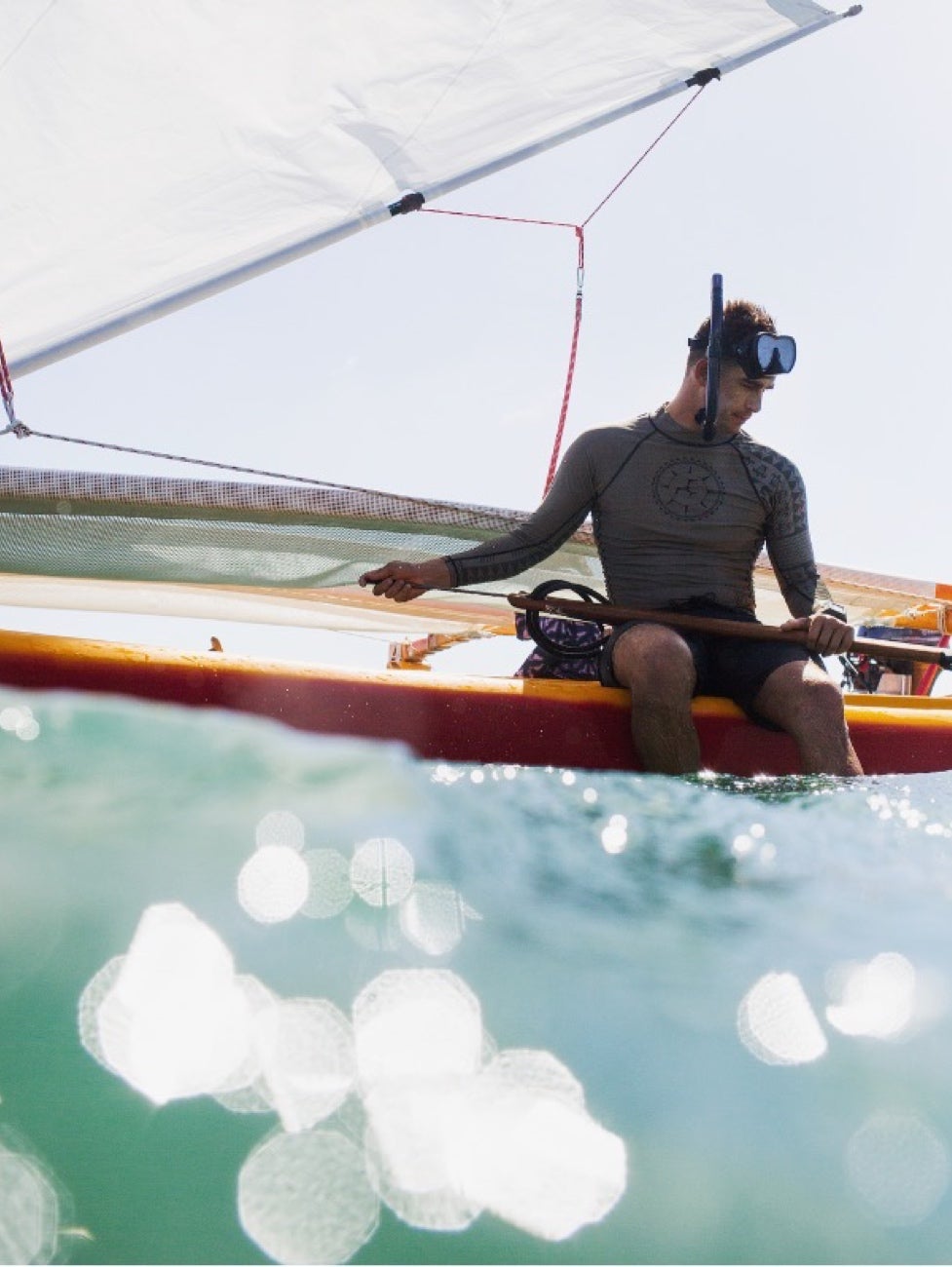 Austin about to do some snorkeling off of his canoe. Smaller boats like the one pictured, he says, are for coastal sailing around an island, whereas larger deep-sea voyaging canoes are capable of transporting a crew and cargo thousands of miles. 