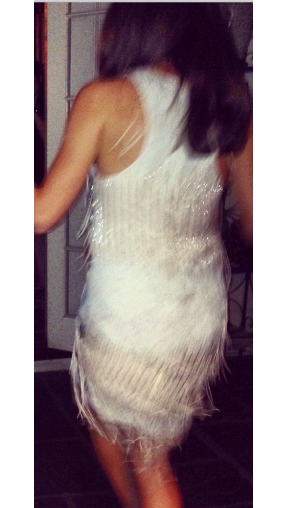 In a beaded fringe dress celebrating New Year’s Eve